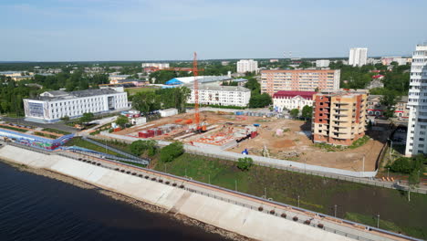 aerial view of a city with a river and a large construction site