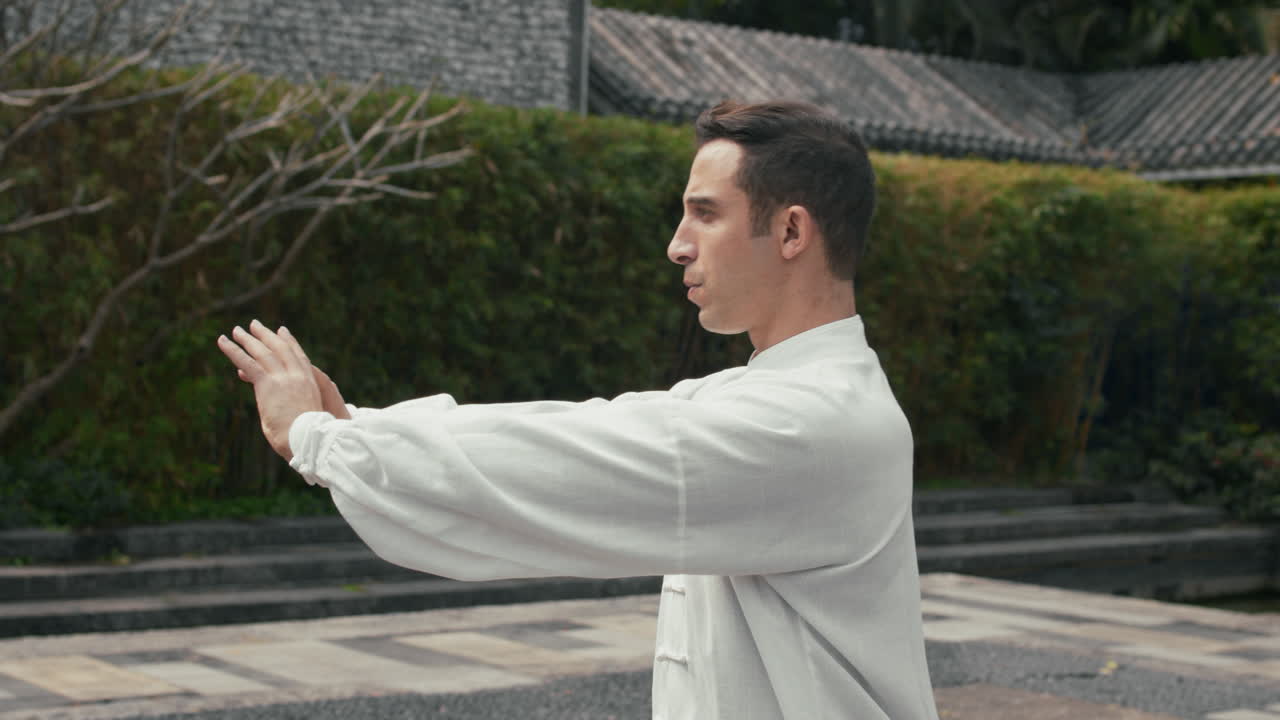 Man Practicing Tai Chi in an Outdoor Garden