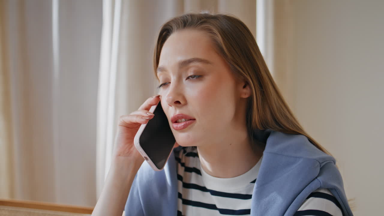 Smart woman consulting smartphone in apartment closeup. Businesswoman calling