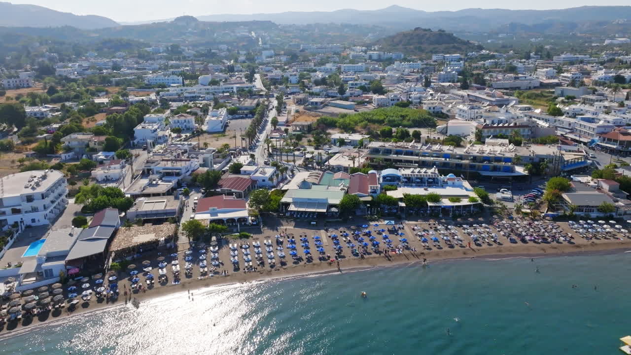 Drone circling the coastline of the Faliraki town, in sunny Rhodes, Greece