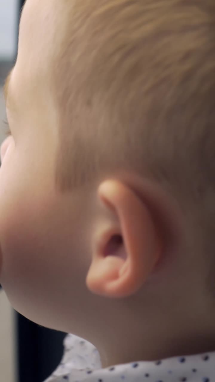 Close-up of a boy's face near a window