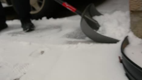 a driveway is shovelled after a light snowfall