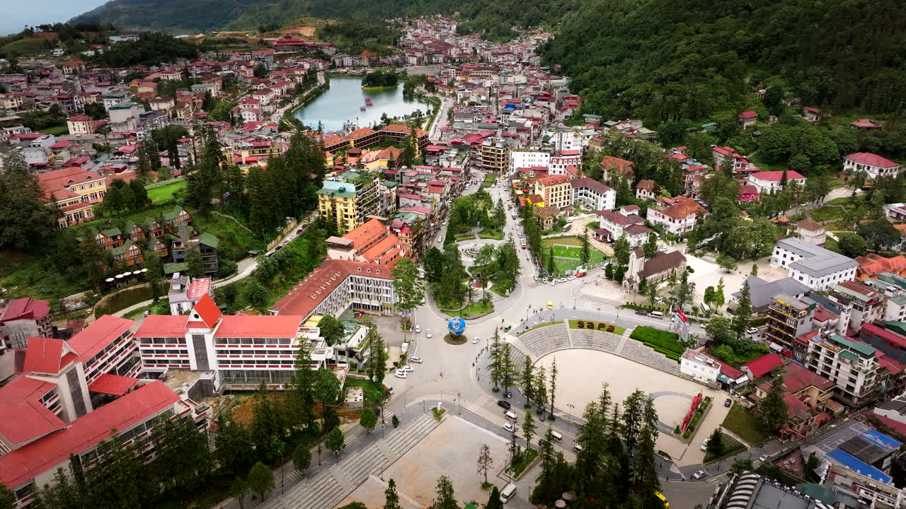 Sapa center in mountainous landscape of Northern Vietnam, aerial pullback