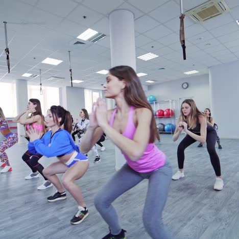 group of sportive people in gym training
