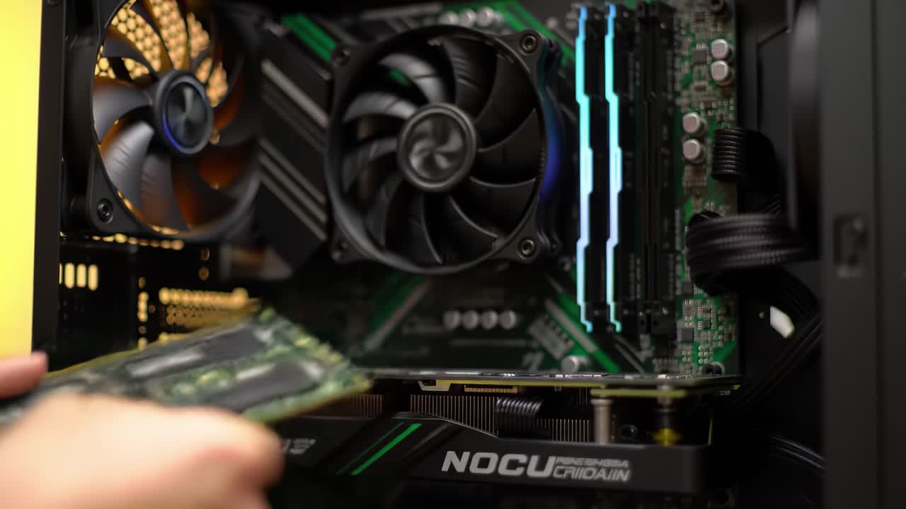 Assembling a Computer: A Step-by-Step Guide to Installing Graphics Card and Cooling System in a Gaming PC Build