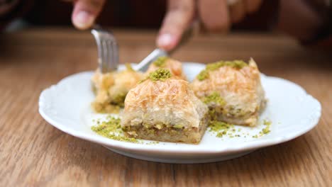 cutting into a plate of baklava