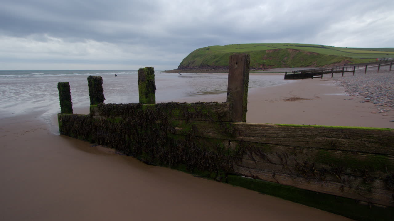 Cloudy Day at the Beach with Wooden Groyne