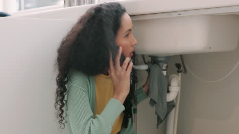 Sink-repair,-plumbing-and-woman-on-a-phone-call