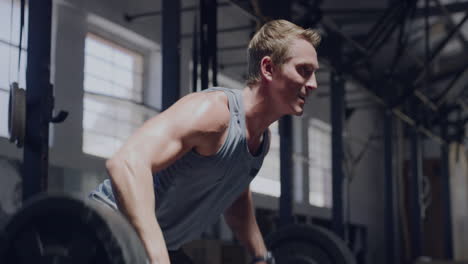 muscular man lifting a barbell while doing bent