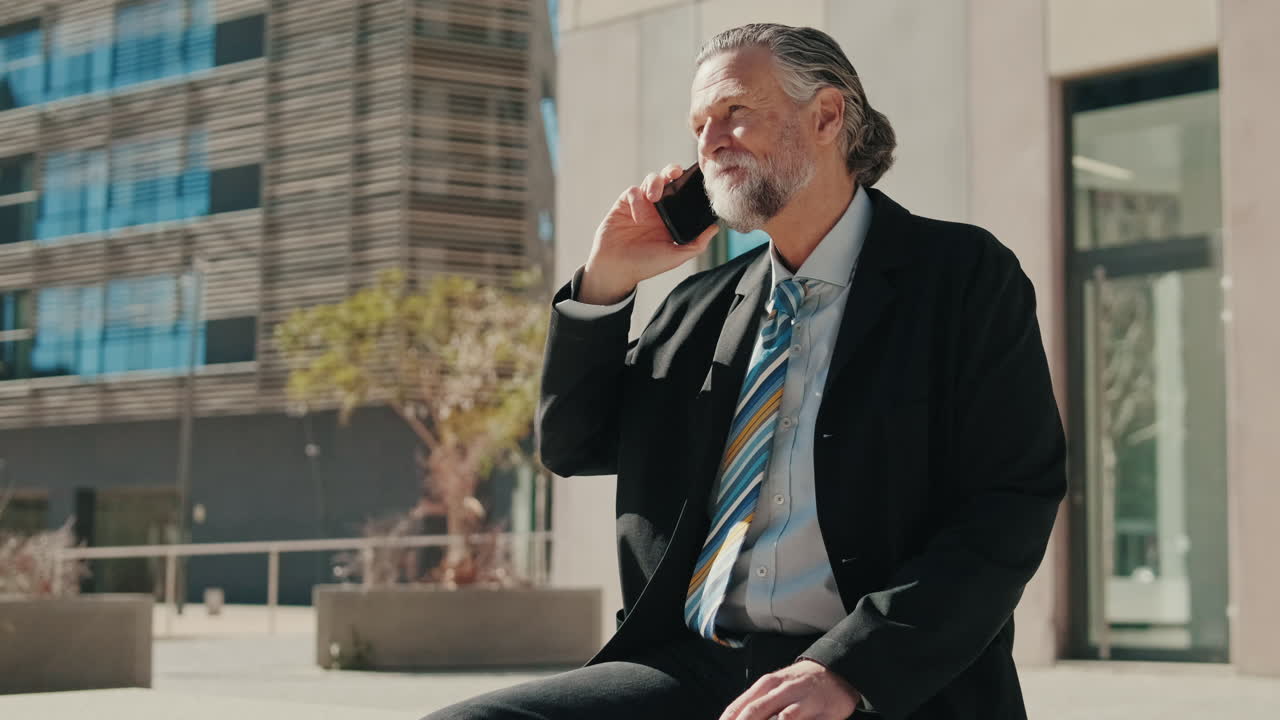 Businessman in Suit Talks on Smartphone Outside Office