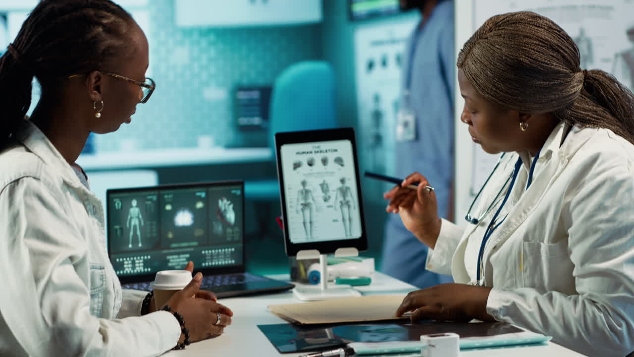 Health specialist advising a young patient during a clinic checkup visit