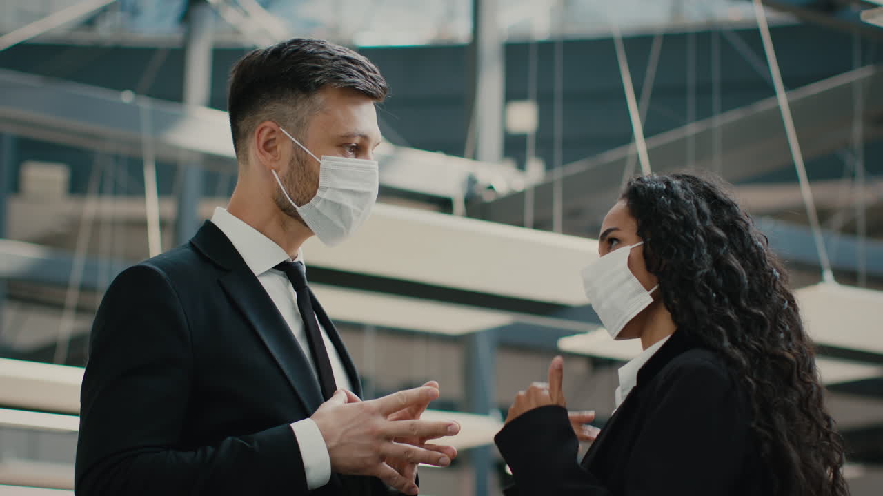 Businesspeople in masks having a conversation