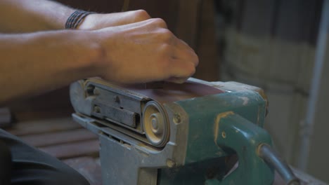 Sanding-Anchor-bracelet-using-upturned-belt-sander