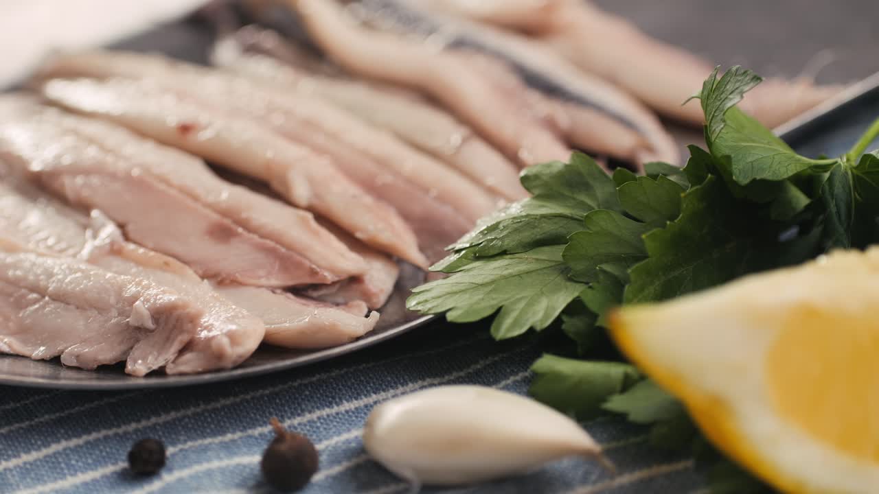 Fresh Sea sardines and Anchovy Fish and Mullus On Display On Ice On Market Store Shop. Seafood Fish Background, close up stand of small salty white fish.
