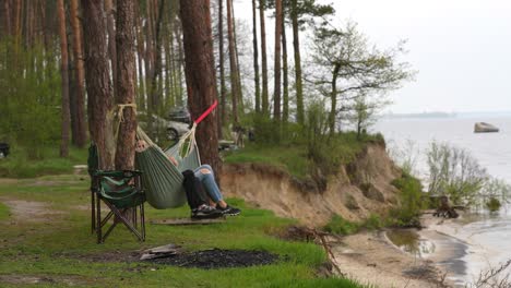 relaxing by the river in a forest camping spot