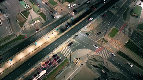 Top-down-night-city-roads-with-cars-driving-aerial-view