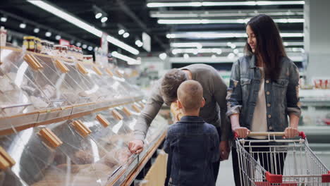 family shopping for bread at grocery store