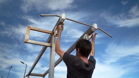 Young Man Exercising And Doing Push Up On Pull Up Bar At Outdoor Gym