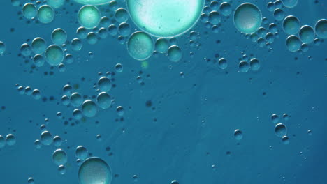 macro shot of a blue liquid with transparent bubbles