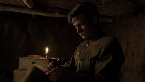 world war i soldier reading a letter in a trench