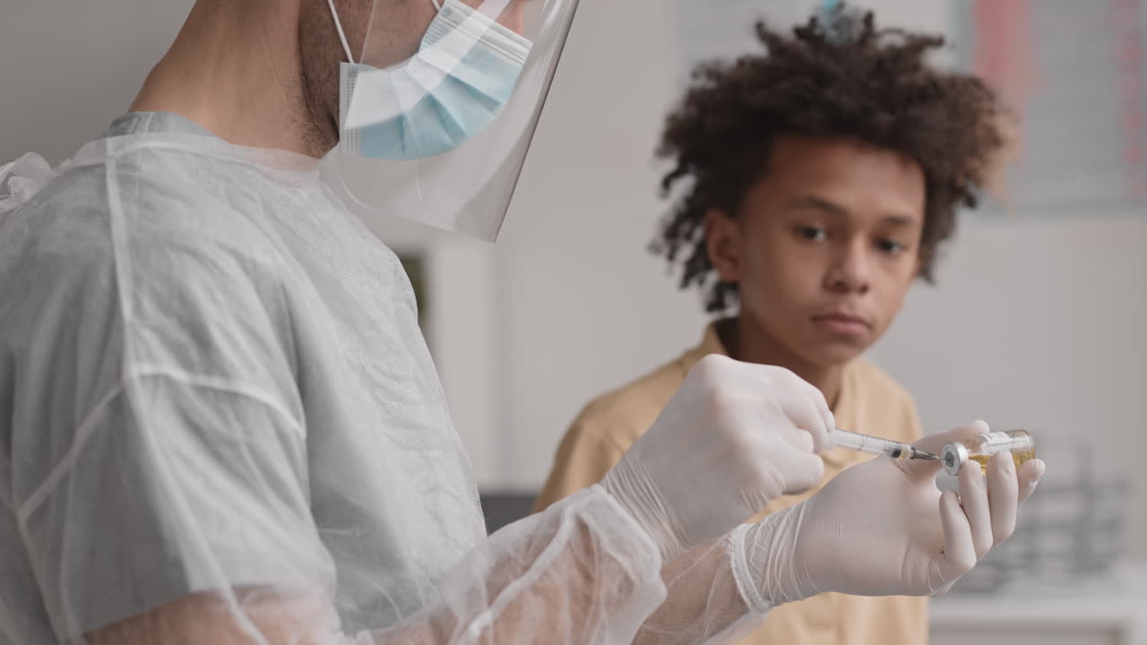 Medical Worker Filling Syringe with Medicine