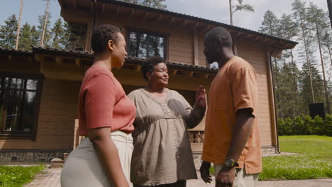 Happy-Family-Talking-And-Hugging-Outside-Home-In-A-Sunny-Morning