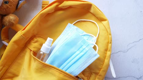 child's backpack with masks and sanitizer