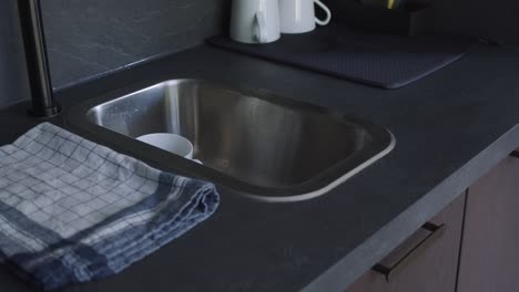 Woman-Put-The-White-Cup-In-The-Sink-After-Drinking