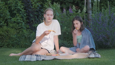 sisters enjoying a picnic in the garden