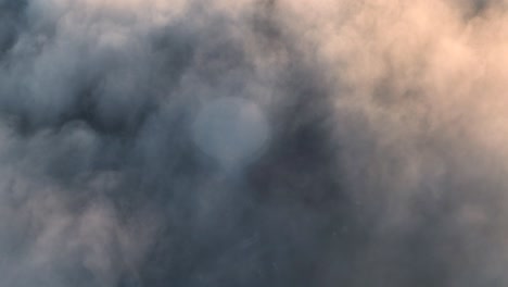 aerial drone shot flying above the clouds