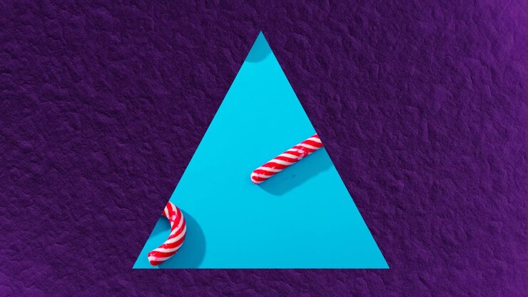 Animation of triangle frame with christmas candies on blue background