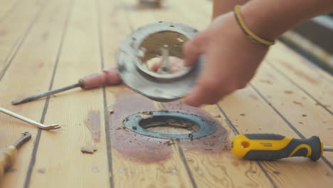 removing vent on roof of old wooden boat close up