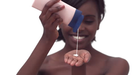 woman pouring lotion into her hands