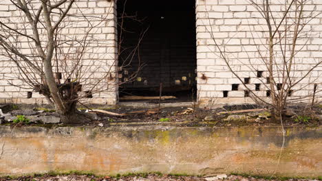 abandoned white brick house in poor countryside neighbourhood near the river