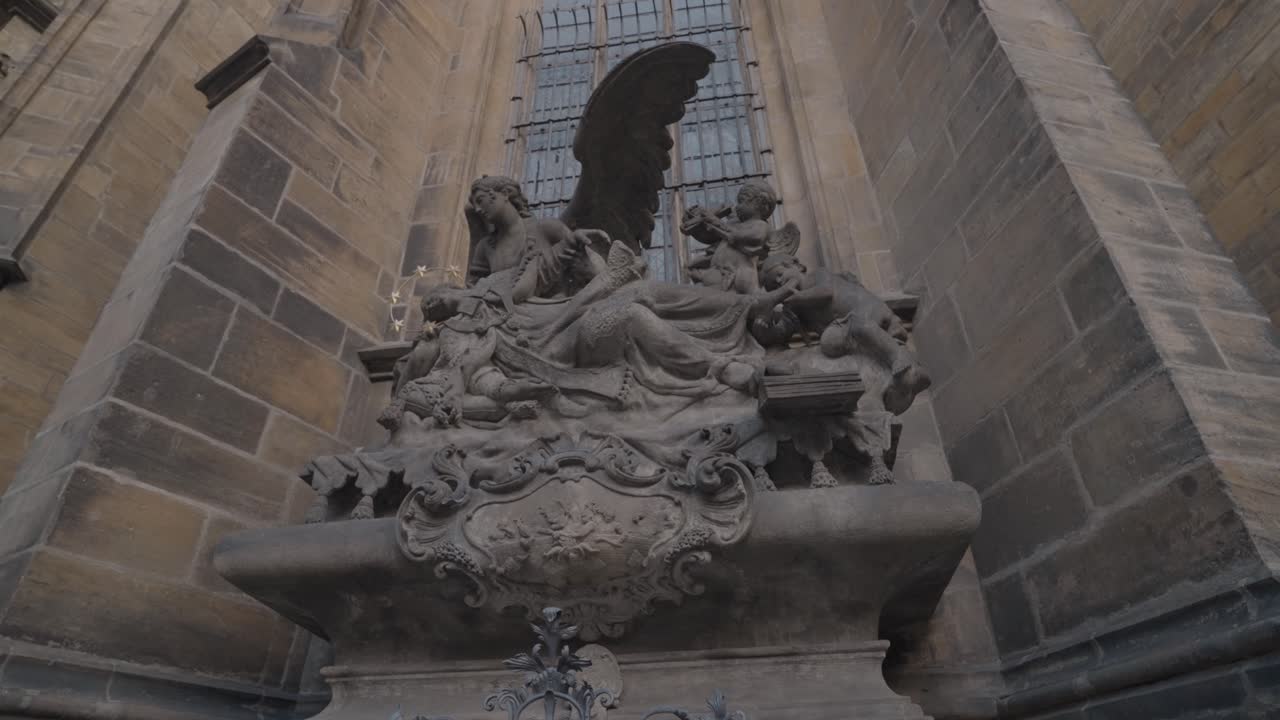Exterior shot of a stone statue next to a building