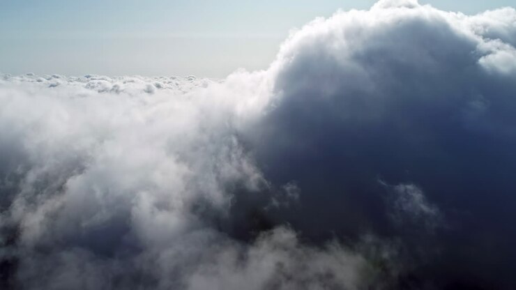 Aerial drone shot flying through amazingly beautiful white clouds