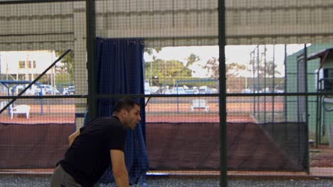 hispanic man in a padel game slams or spikes the ball in slow motion