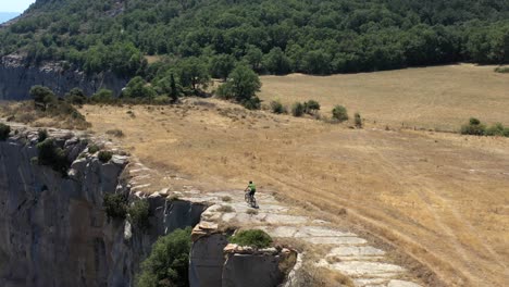 Descenso-Arriesgado-En-Bicicleta-De-Montaña-Muy-Cerca-Del-Borde-De-La-Pared-Del-Cañón,-Antena