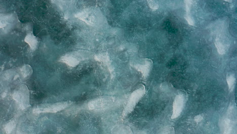 aerial shot of ice blue frozen lake