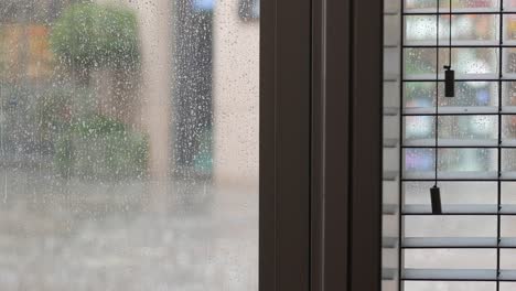 rainy day window view with blinds