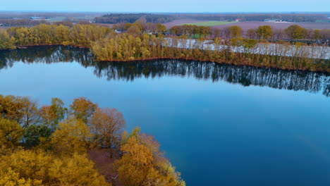 Exploring Dutch waterways. Stunning aerial view of calm waterways in the Netherlands, surrounded by golden trees during autumn