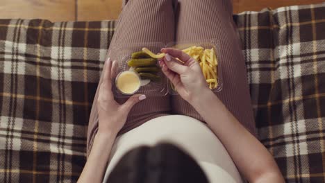 pregnant woman eating fries and pickles