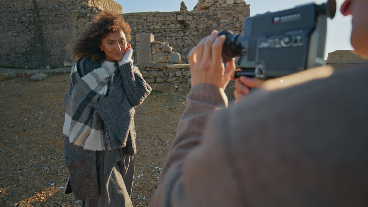 Tender lady posing camera at sundown beach closeup. Photographer filming model