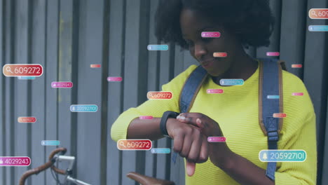 animation of social media icons and data over african american woman using smartwatch