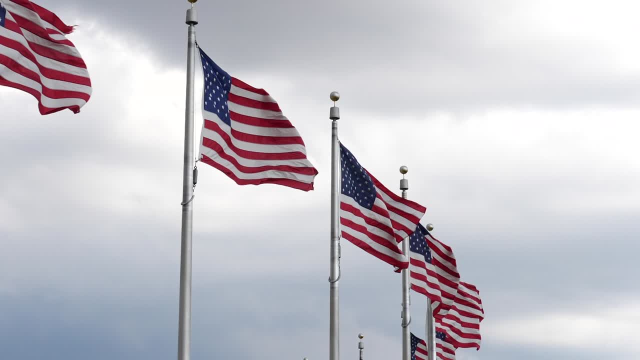 Close up of American flags at the Washington Monument located in Washington DC in the USA