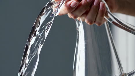 pouring water from a glass jar