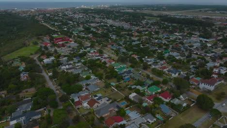 Aerial-panoramic-footage-of-residential-neighbourhood.-Low-family-houses-with-colour-roofs.-Port-Elisabeth,-South-Africa