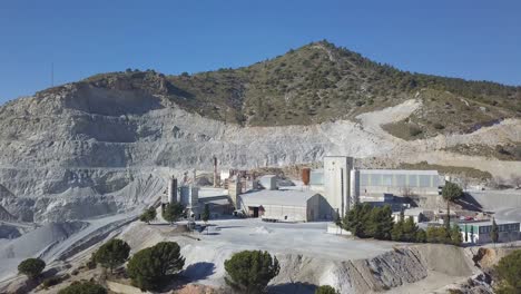 aerial ascending view of a big quarry in a mountain