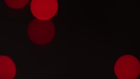 christmas blur background. shimmering colored circles defocused christmas lights video. multicolored light leaks 4k footage on black background