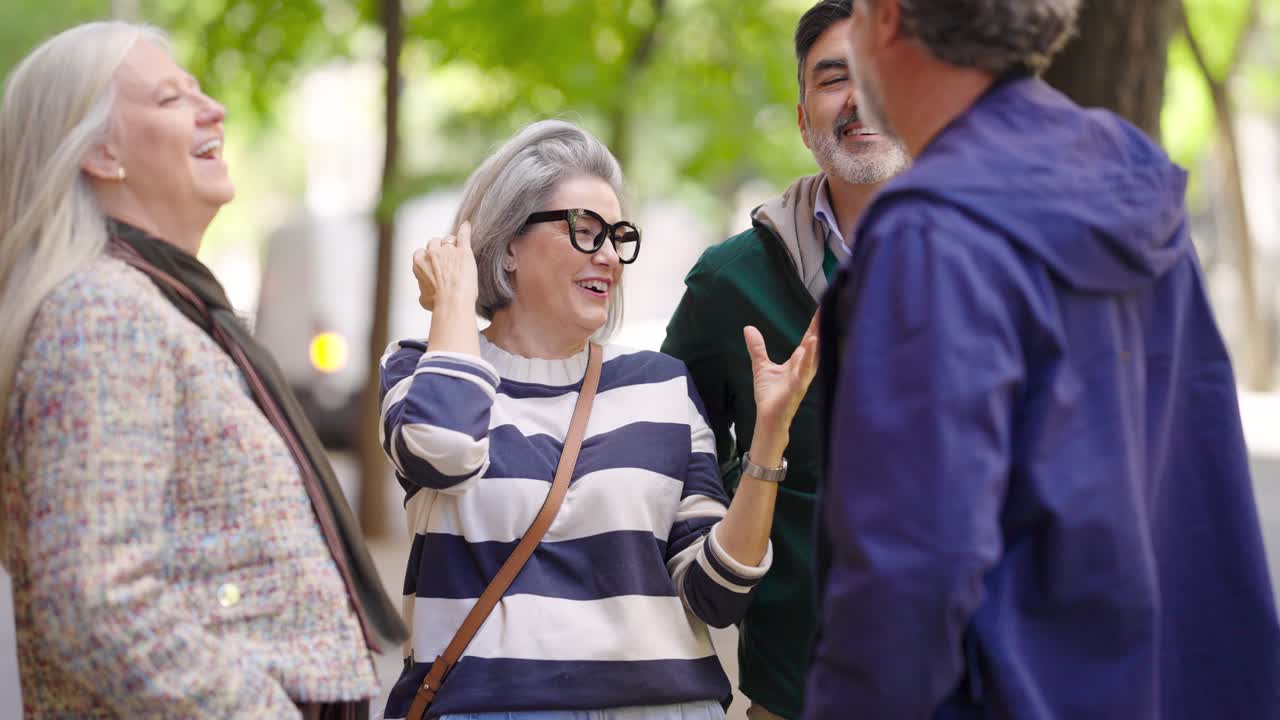 Group of mature people having a conversation outdoors